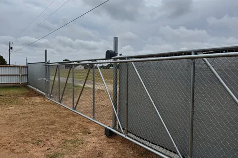 Galvanized chain link fence with cantilever slide gate installed by Hudson Fence Company in Lubbock, TX