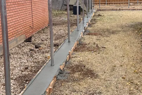Concrete footing forms set for a fence project by Hudson Fence Company in Lubbock, TX